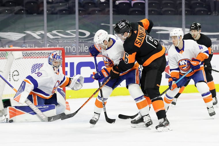 Flyers defenseman Travis Sanheim takes a shot, but goaltender Ilya Sorokin makes a first-period save on Sunday.