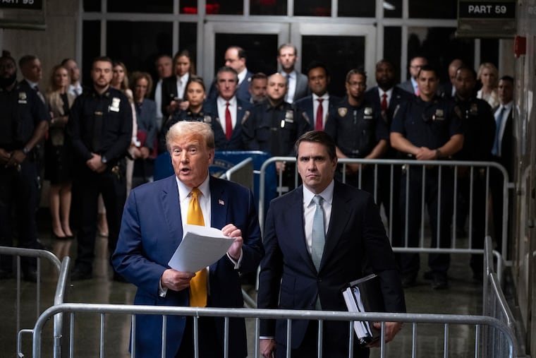 Donald Trump, standing with defense attorney Todd Blanche, speaks at the conclusion of proceedings at his trial in Manhattan criminal court on May 14 in New York.