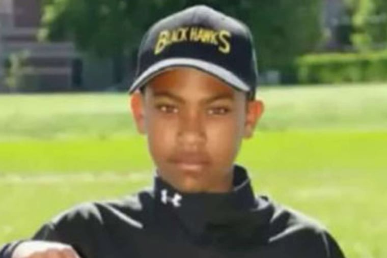 Duval Johnson in his baseball uniform and hanging out at home.Johnson was killed days after his 14th birthday.