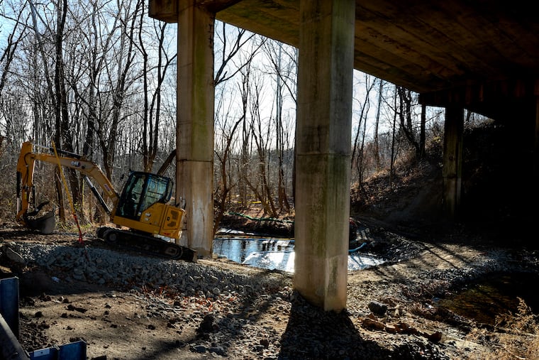 Remediation work continues on Ridley Creek Tuesday, Dec. 9, 2025, under the Route 1 overpass in Media, Delaware County, where a tanker overturned spilling thousands of gallons of home heating oil in September.