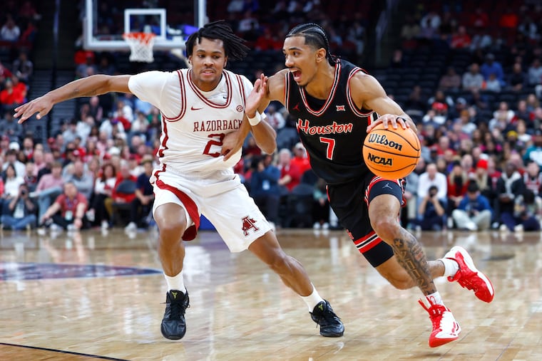 D.J. Wagner of Arkansas guards Houston's Milos Uzan during the first half Saturday in Newark, N.J.