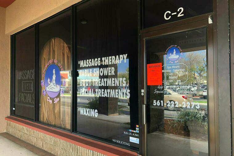 FILE- In this Feb. 19, 2019 file photo, a sign is posted outside Orchids of Asia Day Spa in Jupiter, Fla. A photo published Friday, March 8, 2019, in the Miami Herald shows Li Yang, the founder and one-time owner of the spa implicated in a human-trafficking ring attended a Super Bowl watch party at President Donald Trump's West Palm Beach country club nineteen days before New England Patriot owner Robert Kraft was with charged with prostitution at the spa. (Hannah Morse/Palm Beach Post via AP, File)