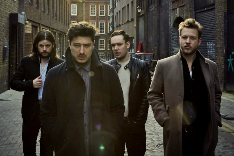 Mumford & Sons members (from left) Winston Marshall, Marcus Mumford, Ben Lovett, and Ted Dwane. The Grammy-winning folk band has gone electric on "Wilder Mind," its third album. "I don't think we ever felt like purists to one set of instruments or one style of songwriting," says lead vocalist Mumford. (James Minchin III)