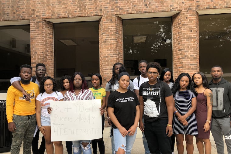 Giavanna Roberson (in front, right of the student holding the sign) and Altaif Hassan (right of Roberson) were the students in the car stopped by police at Rowan University. Other students offer support and are upset at the police action.