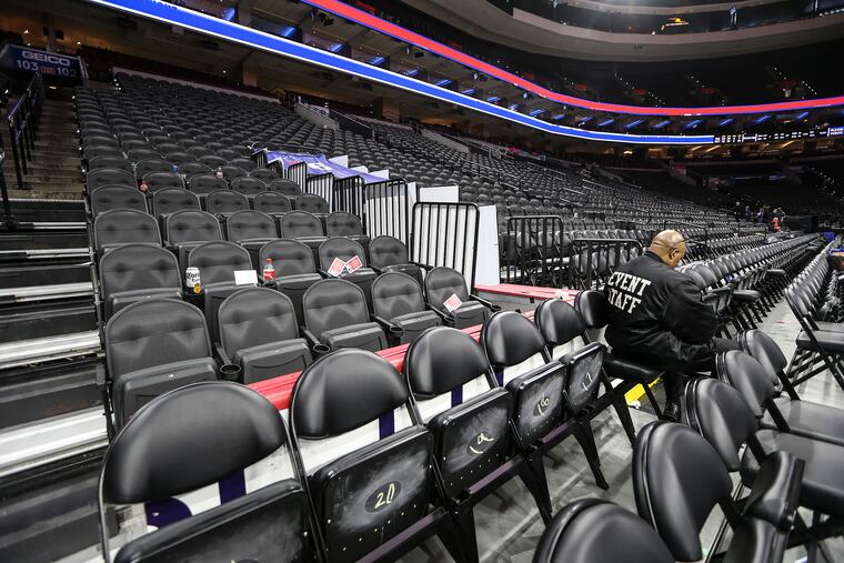 Eddie Robinson, a worker at the Wells Fargo Center, sits after the Sixers-Pistons game during a local youth contest Wednesday. The arena got an extensive scrub-down on Thursday.