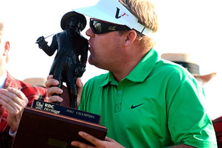Carl Pettersson kisses the trophy after winning the RBC Heritage golf tournament. (Jonathan Dyer/The Island Packet/AP)