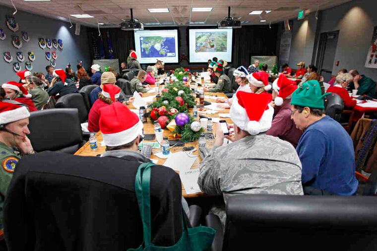 Santa trackers field calls and answer e-mails at NORAD Tracks Santa, Peterson Air Force Base, Colo. Tracking Santa's travels is a celebrated tradition in its 55th year.
