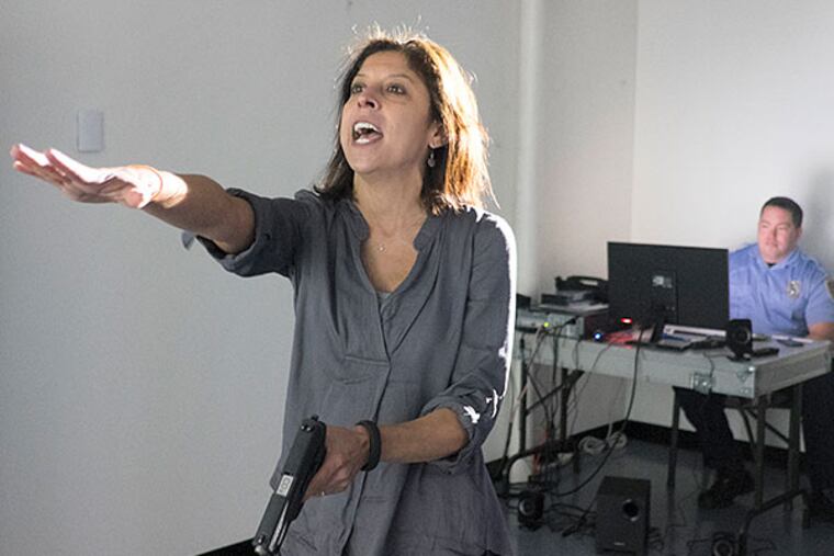 Helen Ubiñas, in a potentially violent situation at the training facility. ED HILLE / Staff Photographer