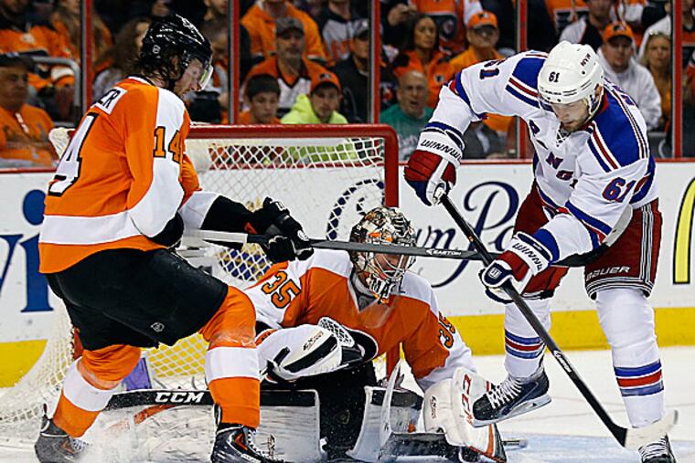 Flyers goalie Steve Mason and center Sean Couturier. (Yong Kim/Staff Photographer)