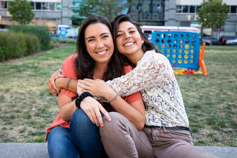 Ellen Carney, left, managing director of the Happy Kids Center in Nepal, with her dear friend an co-worker Nicole Heker, 26, who is the development director of the center, reunite at Love Park in Philly. Carney is from Wyndmoor, Pa., Heker is from Princeton, N.J. The two became friends in Thailand and joined the Happy Kids Center in Nepal after double earthquakes occurred there in 2015. "Once you meet the kids, you can't leave," Carney said, who can't wait to return to Nepal. "They're so appreciative of everything you do for them."