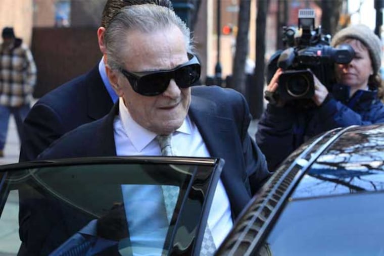 Fortunato Perri Sr., former Traffic Court judge, is assisted into a car by his defense attorney after pleading guilty to four felonies in March 2013. (Jad Sleiman / Staff)