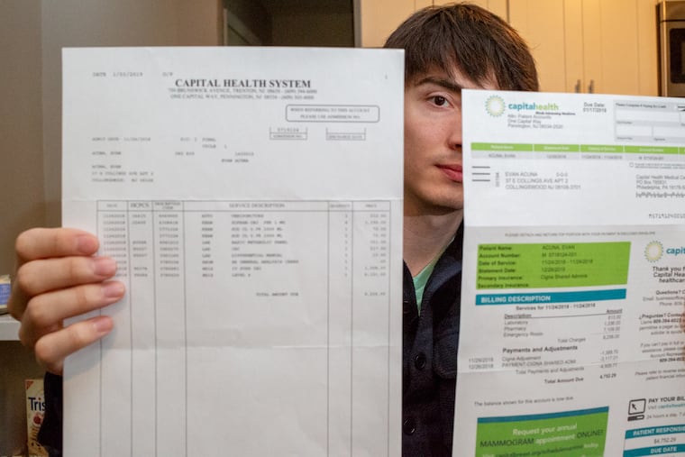 Evan Acuna, 27, displays bills from a trip to the ER in November at his home in Collingswood NJ, Monday, February 18, 2019.