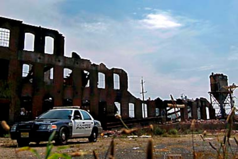 A Camden policeman is positioned at the site of an 8 alarm fire that occured on June 11, 2011 at the intersection of Broadway and Winslow in Camden. This photo was taken on June 20, 2011. ( Elizabeth Robertson / Staff Photographer ) EDITORS NOTE: JFIRE20 A Camden policeman is positioned at the site of an 8 alarm fire that occured on June 11, 2011 at the intersection of Broadway and Winslow in Camden. This photo was taken on June 20, 2011.