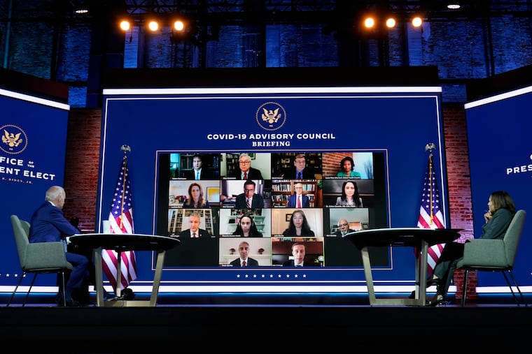 President-elect Joe Biden and Vice President-elect Kamala Harris listen during a meeting with Biden's COVID-19 advisory council Monday at the Queen theater in Wilmington.