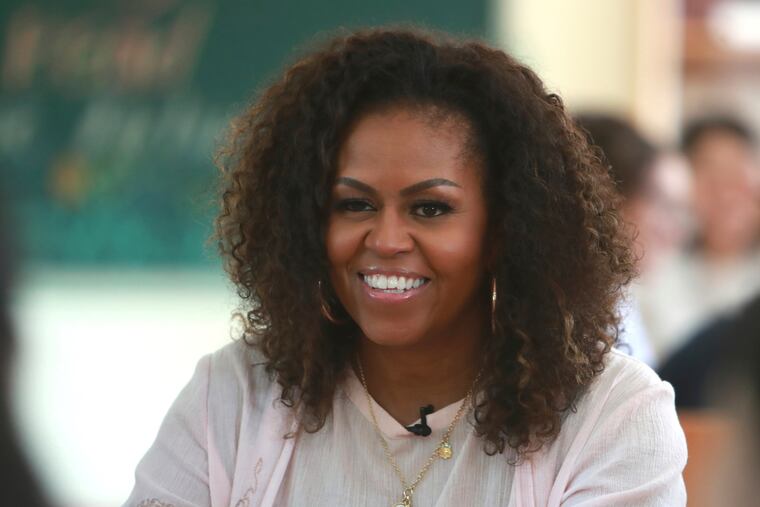 Former U.S. first lady Michelle Obama listens to female students at the Can Giuoc high school in Long An province, Vietnam, Monday, Dec. 9, 2019. Mrs. Obama is on a visit to Vietnam to promote education for adolescent girls. (AP Photo/Hau Dinh)