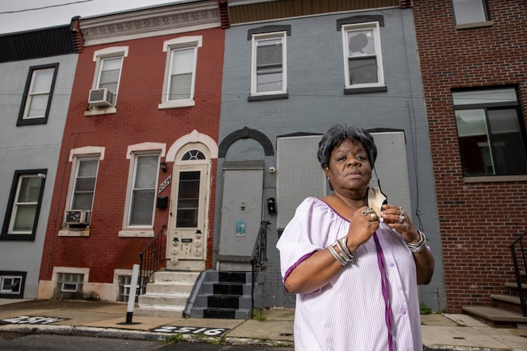 Lalla G. Jones at her home on Ingersoll Street on Tuesday. She lives next to an empty property that, according to her, is flooding her house with cockroaches.