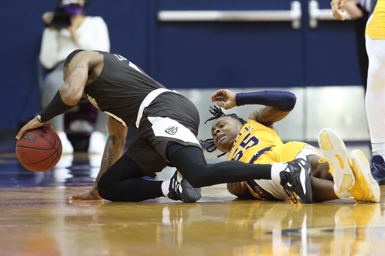 Khalil Brantley, right, of La Salle and Kyle Lofton of St. Bonaventure after a collision during the 1st half on Jan. 11, 2022.