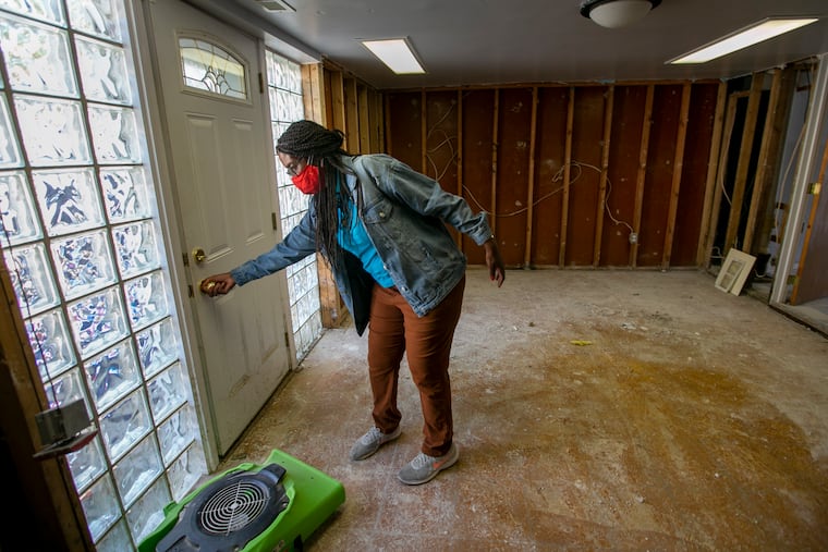 Jennifer Nesbitt, resident of 8000 block of Buist in Eastwick section of Philadelphia shows the water damage from Tropical Storm Isaias to her basement on Wednesday, August 19, 2020.