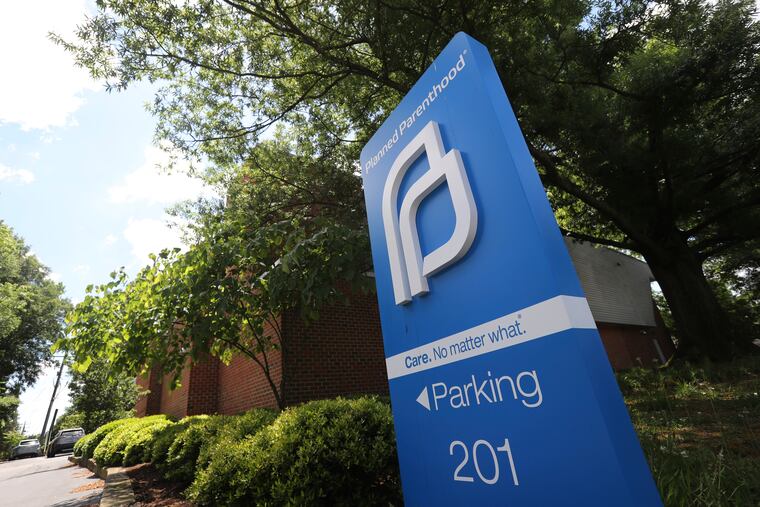 This May 15, 2019 photo shows a sign in front of the Planned Parenthood offices in Richmond, Va. Fetal heartbeat and other strict state abortion laws pushed by anti-abortion groups have grabbed headlines and captured the nation's attention. But pro-abortion rights groups have been waging a quieter battle in courthouses around the country, where they have put on their own push to overturn state restrictions on abortion providers. (AP Photo/Steve Helber)