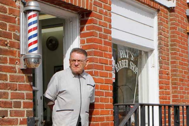 Pat Shannon, who turns 70 on Friday, takes a break between customers outside Pat's Barber Shop in Wayne. ( MICHAEL S. WIRTZ / Staff Photographer )