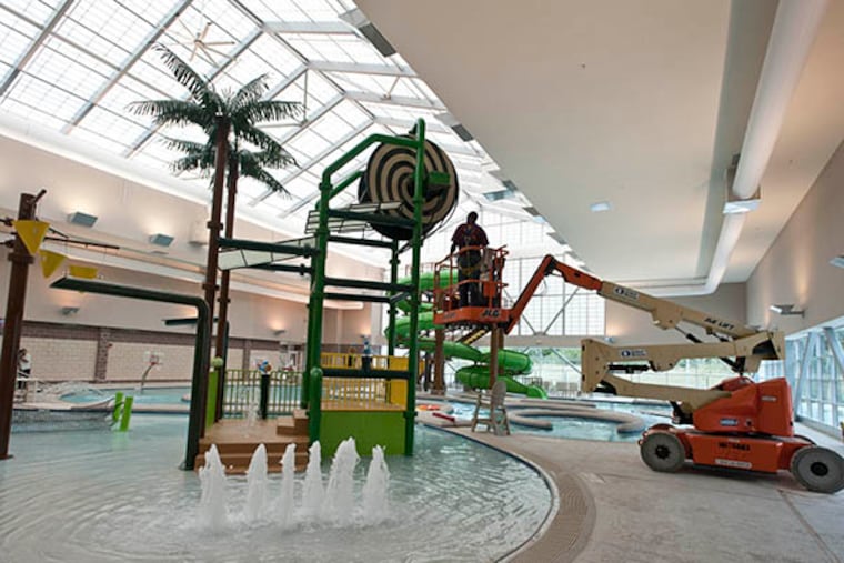 A worker puts the final touches on the children's pool area in the aquatics center at the Ray and Joan Kroc Corps Community Center in Camden, N.J. ( RON TARVER / Staff Photographer )