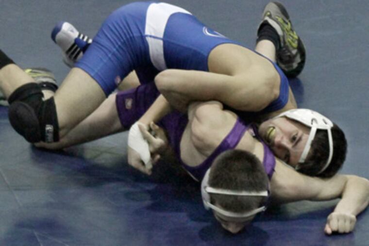 Norristown's Zach Fuentes (top) controls, and eventually pinned, Upper Moreland's Tommy Lloyd in the 113 lb match during the Upper Moreland at Norristown H.S. wrestling match on January 11, 2012. ( Elizabeth Robertson / Staff Photographer ) EDITORS NOTE: SNORR12 126568 Upper Moreland at Norristown H.S. wrestling match.