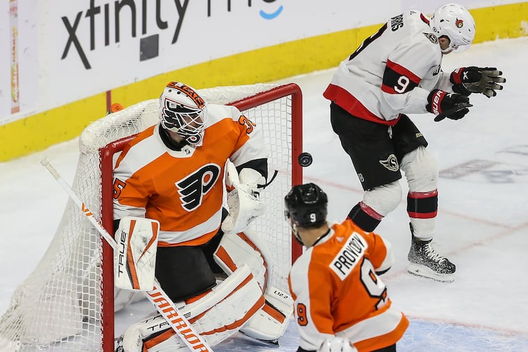 Flyers goalie Martin Jones deflects a shot on goal with help from Ivan Provorov as Senators Josh Norris lost his stick during the second period at the Wells Fargo Center in Philadelphia, Friday, April 29, 2022.