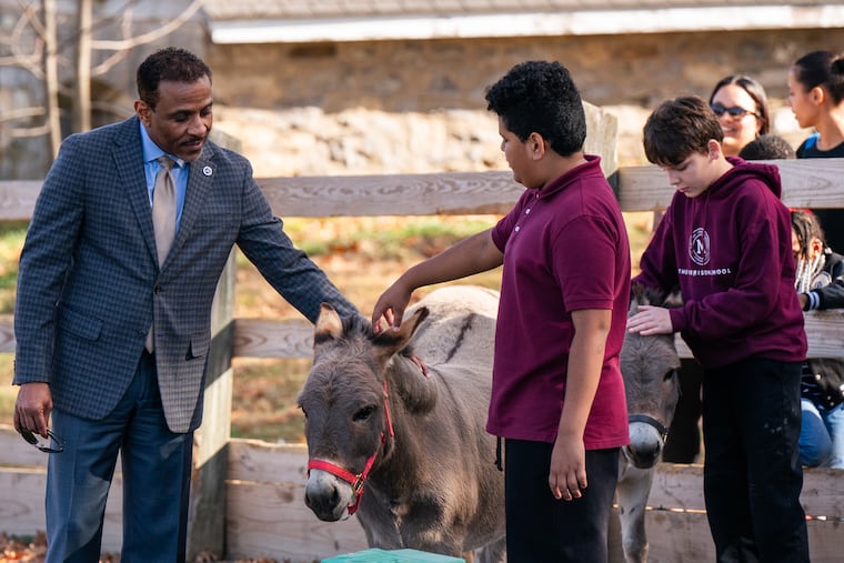 A new program will give Philly students the opportunity to learn social-emotional skills using horses and donkeys. In this photo are (L-R) Tony Watlington, Superintendent of the School District of Philadelphia, Ellen, a donkey who lives at Fox Chase Farm, Michael Castillo, Morrison School 7th Grader, and Jake Em Christian, Morrison School 7th Grader.