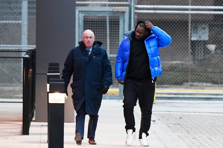 R. Kelly (right) leaves Cook County Jail with his defense attorney, Steve Greenberg, Monday, Feb. 25, 2019, in Chicago. Kelly has been released from jail in Chicago, three days after being booked on charges alleging that he sexually abused four women, including three who were minors at the time. Kelly's release Monday came hours after his lawyer pleaded not guilty on his behalf to all 10 counts of aggravated sexual abuse that the singer faces.