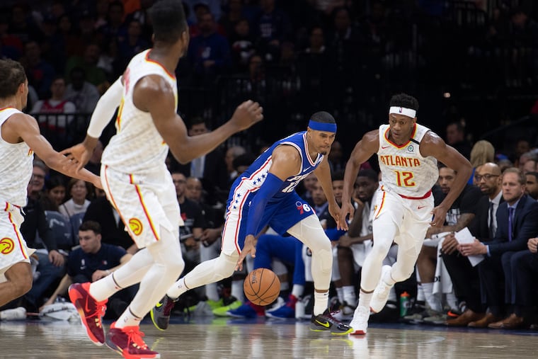 Tobias Harris drives by Atlanta's DelAndre Hunter (12) in February.