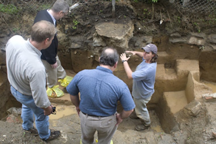 Kimberly Morell (right), manager for a PennDot contractor, reviews the Fishtown dig for local historians (from left) Rich Remer, Torben Jenk, and Kenneth Milano. (Ed Hille / Staff Photographer)