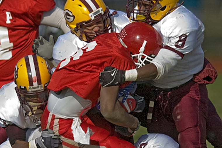 Glassboro defenders surround Paulsboro’s Gerald Hodges in a Group 1 playoff game. The Bulldogs play for the title Saturday. (Clem Murray / Staff Photographer)