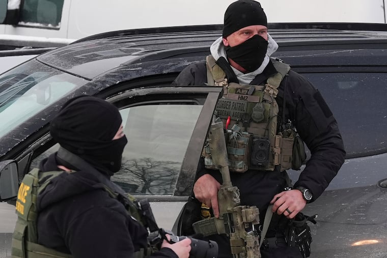 Federal immigration agents at a tense scene in Minneapolis on Sunday. Philadelphia lawmakers will consider a package of bills aimed at controlling immigration enforcement in the city, including a measure that bans law enforcement officers from concealing their identities.