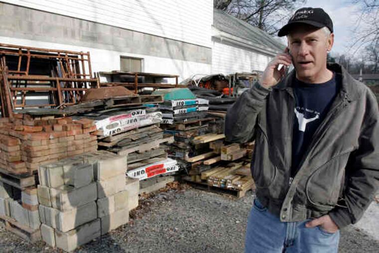 "You take for granted what you have until you see what some people have to live with," says Project RAKE volunteer Bob Henriksen, taking a call at the group's garage in New London.
