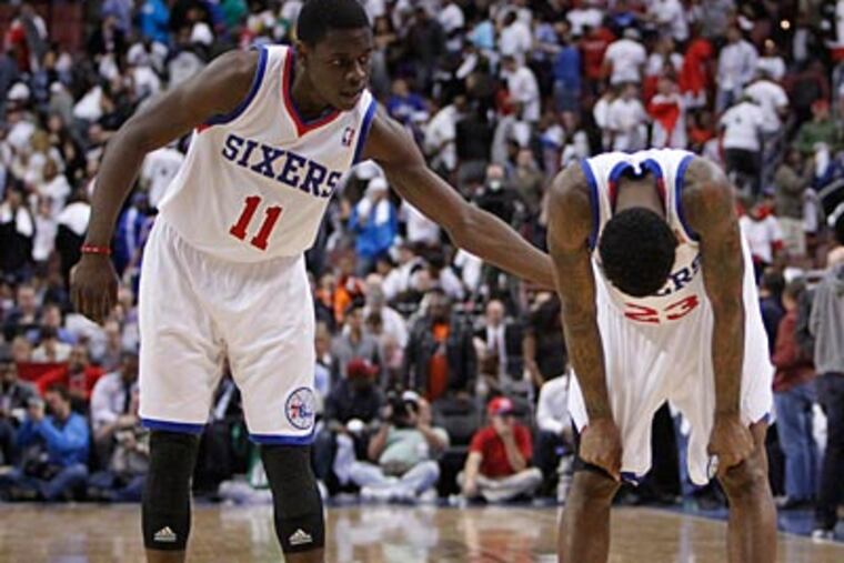 Jrue Holiday consoles Lou Williams after missing a three late in the fourth quarter of Game 3. (Ron Cortes/Staff Photographer)