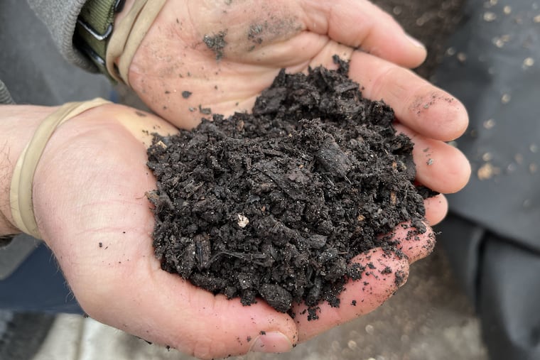 Tim Bennett, of Bennett Compost, holds compost that began as food waste in November. Bennett is in a partnership with Philadelphia to turn waste generated at city recreation centers into compost for community gardens.