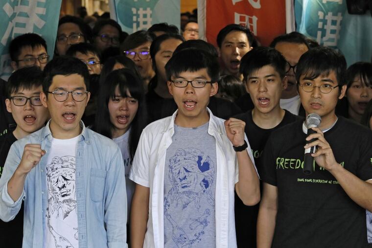 From front left, Hong Kong activist Nathan Law, Joshua Wong and Alex Chow were found guilty of leading or encouraging an illegal rally in September 2014 that kicked off the demonstrations known as the “Umbrella Movement.”