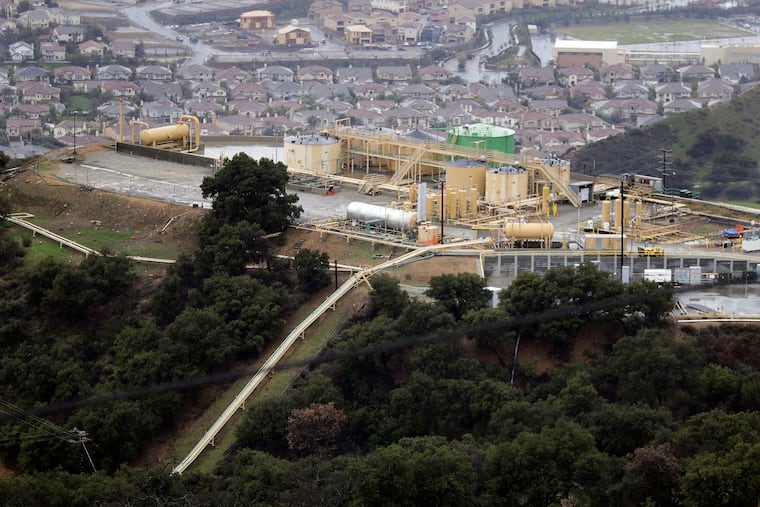 FILE - This Jan. 12, 2017, file photo shows gas gathering plant on a hilltop at the Southern California Gas Company's Aliso Canyon storage facility near the Porter Ranch neighborhood of Los Angeles. An investigation into the cause of the largest-known release of methane in the U.S. faults a California utility for the way it maintained its natural gas storage field before the massive 2015 blowout. The report released Friday, May 17, 2019, by the California Public Utilities Commission says Southern California Gas Co. did not assess its wells for disaster potential and did not investigate previous ruptures.