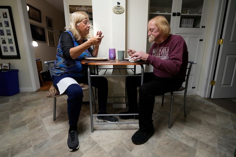 Marsha, left, and Kirk Luce, both patients at New Hampshire's Ammonoosuc Community Health Services, eat dinner, Thursday, Oct. 23, 2025, at their home in Franconia, N.H. Community health workers can provide patients with assistance between doctor visits. (AP Photo/Robert F. Bukaty)