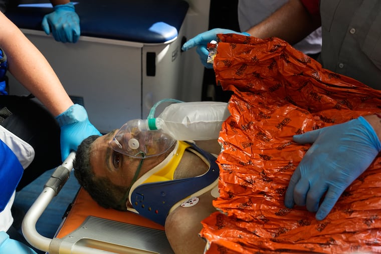 Rescue workers carry Hernan Alberto Gil Flores after he was pulled from the rubble eight days after he was trapped by twin earthquakes that struck Catia La Mar, Venezuela. in Catia La Mar, Venezuela, Thursday, July 2, 2026.