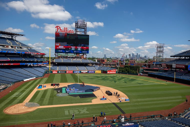 Workers applying the All-Star Game logo on the field at Citizens Bank Park on Wednesday.