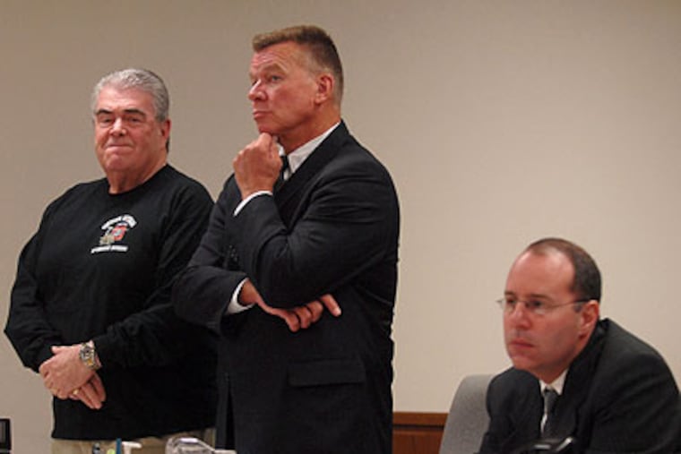 Vietnam veteran William Devereaux (left) appears Friday in Superior Court in Camden as he is sentenced to 30 days of house arrest for improperly accepting benefits after embellishing his military record. Standing with him is attorney Dennis Wixted. At right is prosecutor Mark Chase. (Tom Gralish / Staff Photographer)
