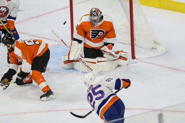 Flyers goalie Carter Hart stops a shot from the Islanders' Sebastian Aho during the first period Tuesday at the Wells Fargo Center.
