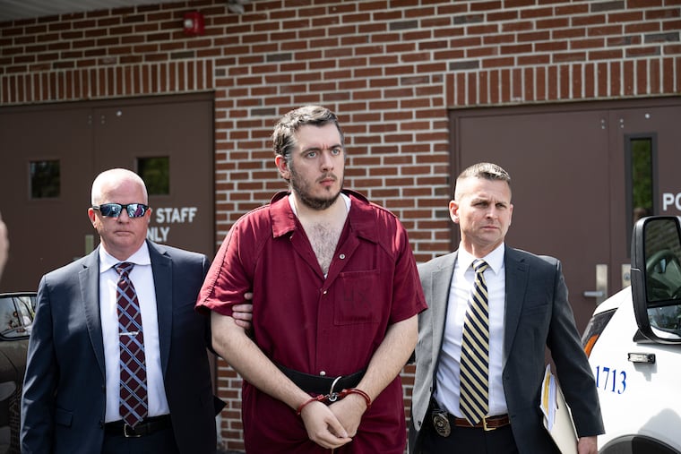 Ryan Selleny is escorted out of magisterial district court in King of Prussia after a preliminary hearing on Tuesday. Selleny has been charged with burglary, theft, indecent assault, and related crimes.