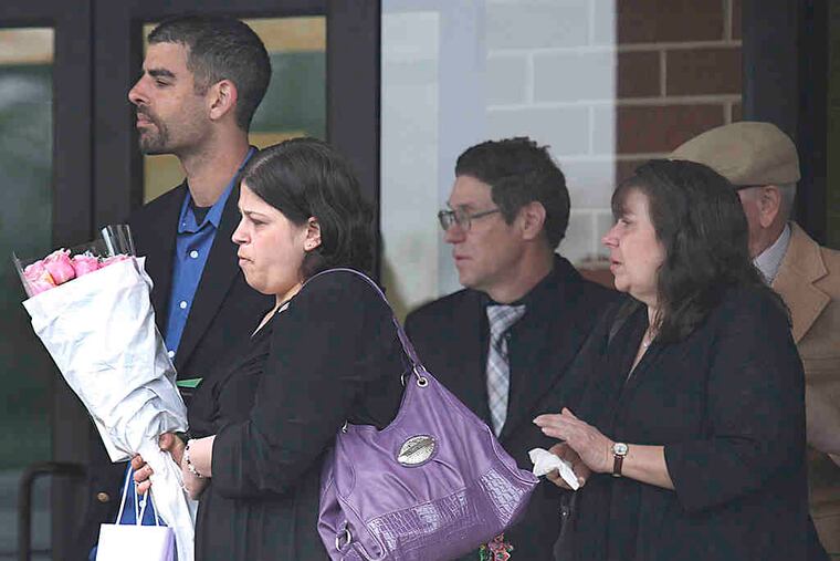 Skyler Kauffman's parents (left), Eric Kauffman and Heather Gebhard , watch as her casket is carried to a hearse at Calvary Church in Hilltown, Bucks County. They chose not to speak at the funeral, but others offered their memories.