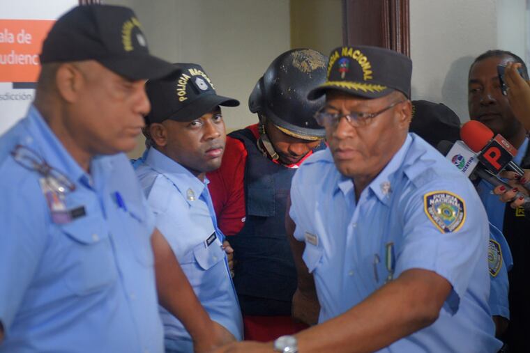 Gabriel Alexander Pérez Vizcaino (in back, wearing helmet), alias "Bone," a suspect in the shooting of former Boston Red Sox slugger David Ortiz, is taken to court in Santo Domingo, Dominican Republic, Monday, June 17, 2019. Ortiz was shot in the back at a bar in the Dominican Republic on Sunday, June 9.