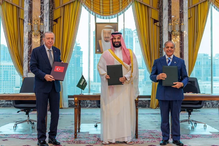 From left, Turkish President Recep Tayyip Erdogan, Saudi Crown Prince Mohammed bin Salman and Pakistani Prime Minister Shehbaz Sharif pose after signing a trilateral defense agreement in Mecca, Saudi Arabia, Friday, Aug. 7, 2026.