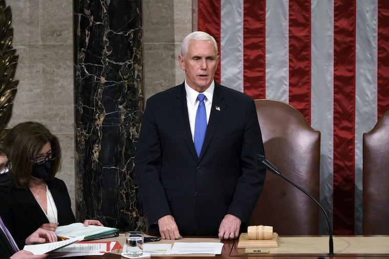 Vice President Mike Pence reads the final certification of Electoral College votes cast in November's presidential election early Thursday morning.