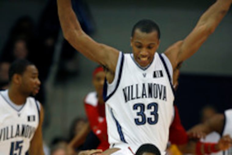 Rutgers' Anthony Farmer loses his footing as Villanova's Dante Cunningham looms over him during the first half.
