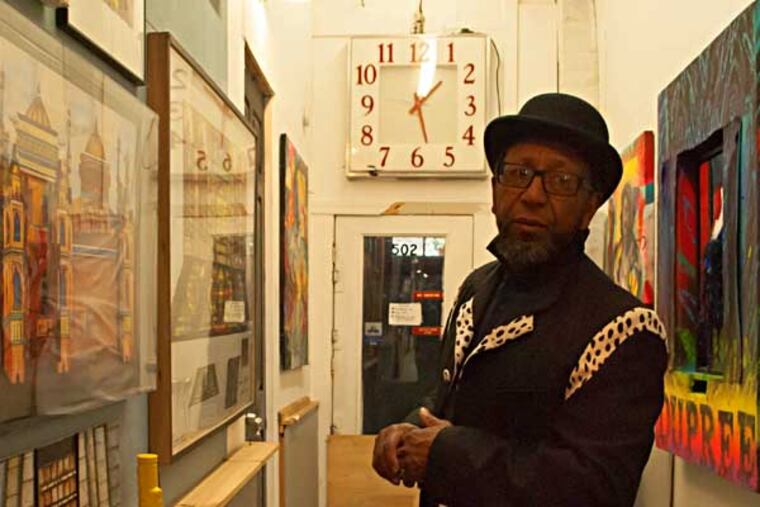 Dupree examins his gallery in his studio in Mantua. (SARA NACHMAN / STAFF PHOTOGRAPHER)